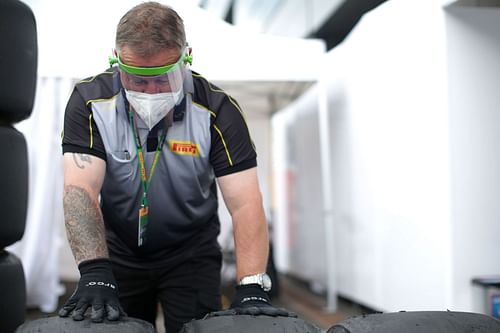 A Pirelli tire technician works on tires (Photo by Peter Fox/Getty Images)