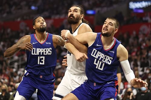 Ivica Zubac #40 and Paul George #13 of the Los Angeles Clippers box out Steven Adams #4 of the Memphis Grizzlies