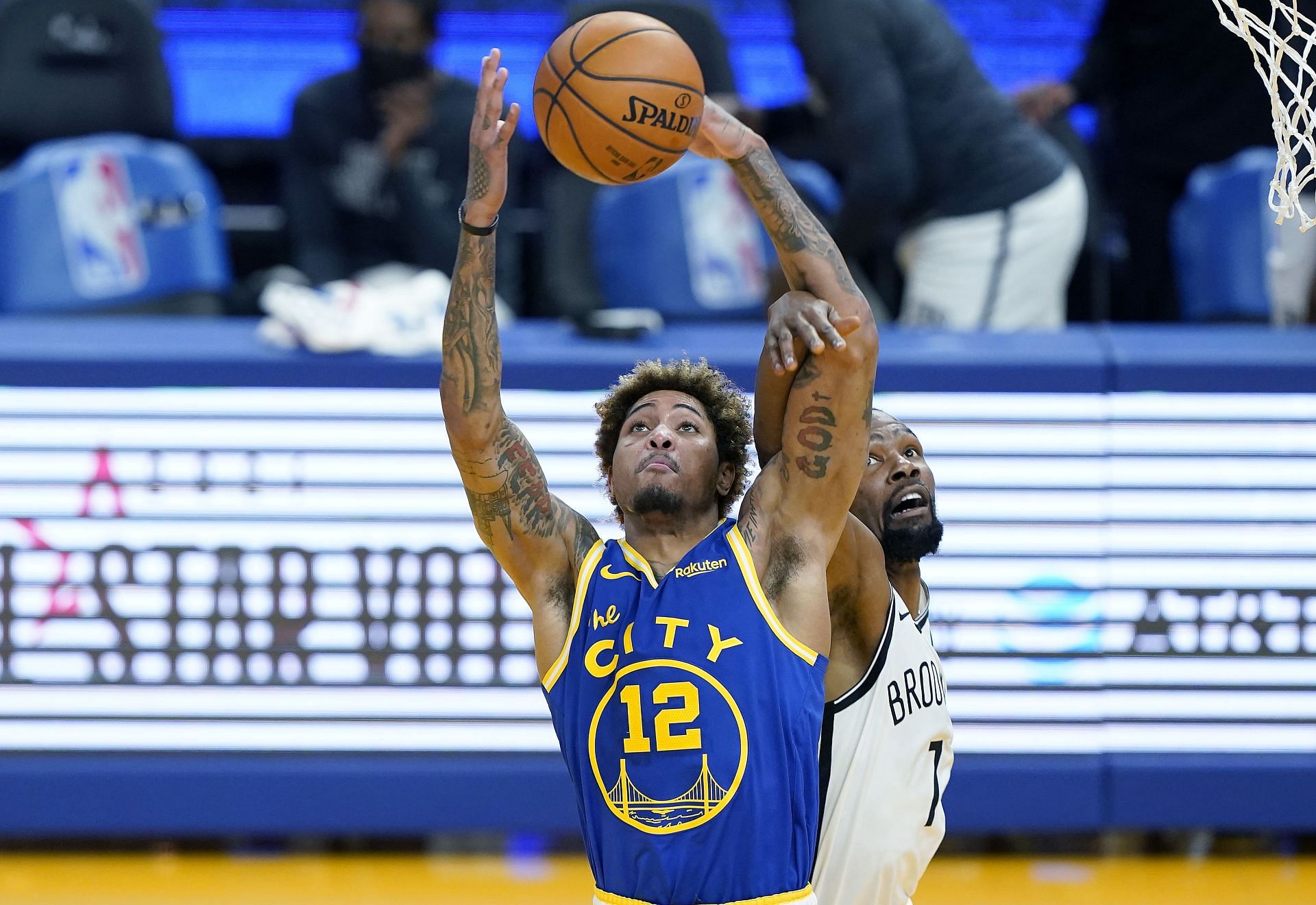 Kelly Oubre Jr. #12 of the Golden State Warriors battles for a rebound with Kevin Durant #7 of the Brooklyn Nets during the second half of an NBA basketball game at Chase Center on February 13, 2021 in San Francisco, California.