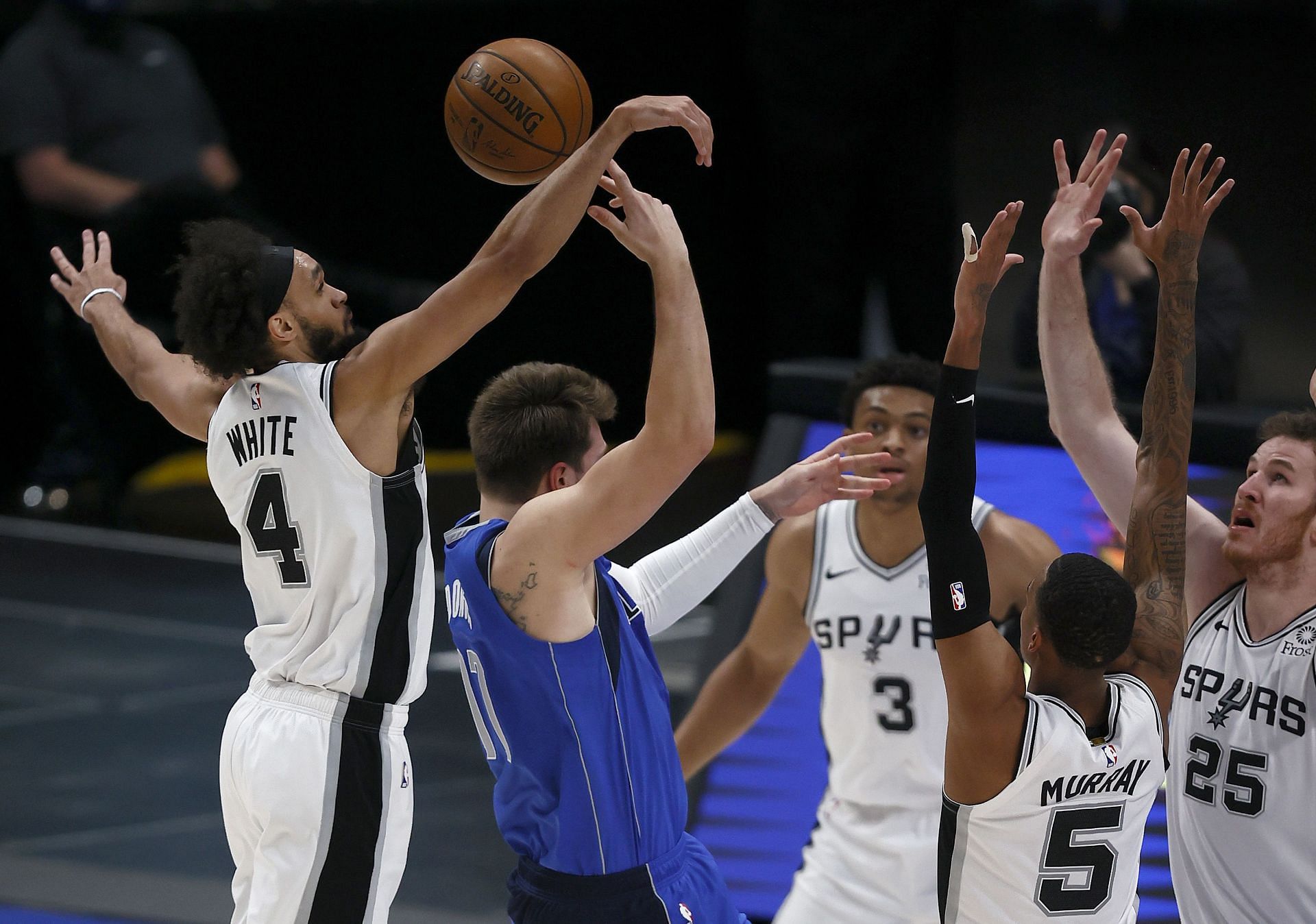 Luka Doncic of the Dallas Mavericks gets surrounded by the San Antonio Spurs