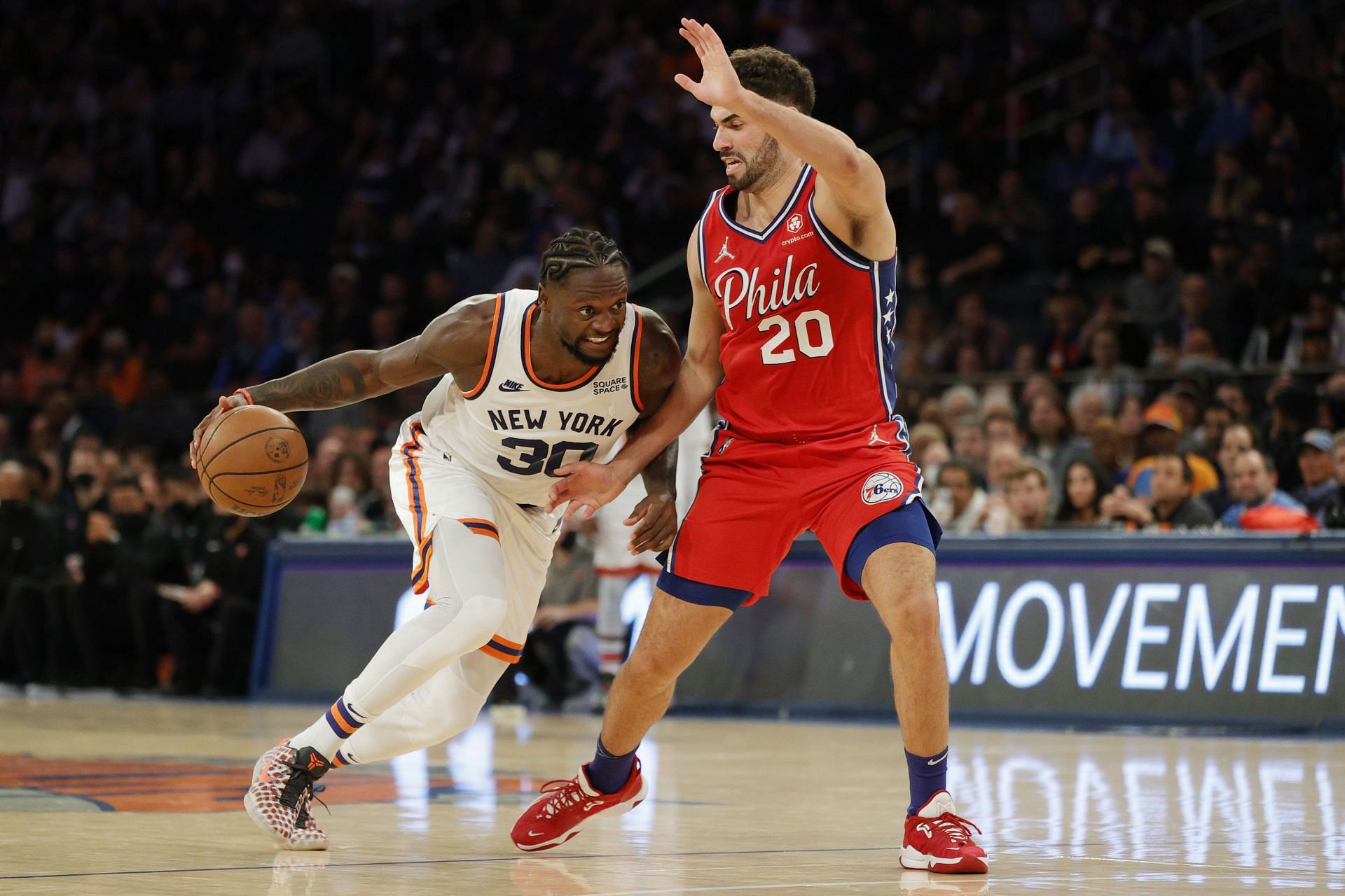 Julius Randle #30 of the New York Knicks dribbles as Georges Niang #20 of the Philadelphia 76ers defends during the second half at Madison Square Garden on October 26, 2021 in New York City. The Knicks won 112-99.