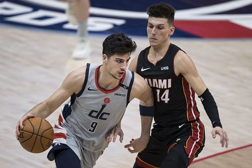 Deni Avdija #9 of the Wizards drives the ball away from Tyler Herro #14 of Miami Heat