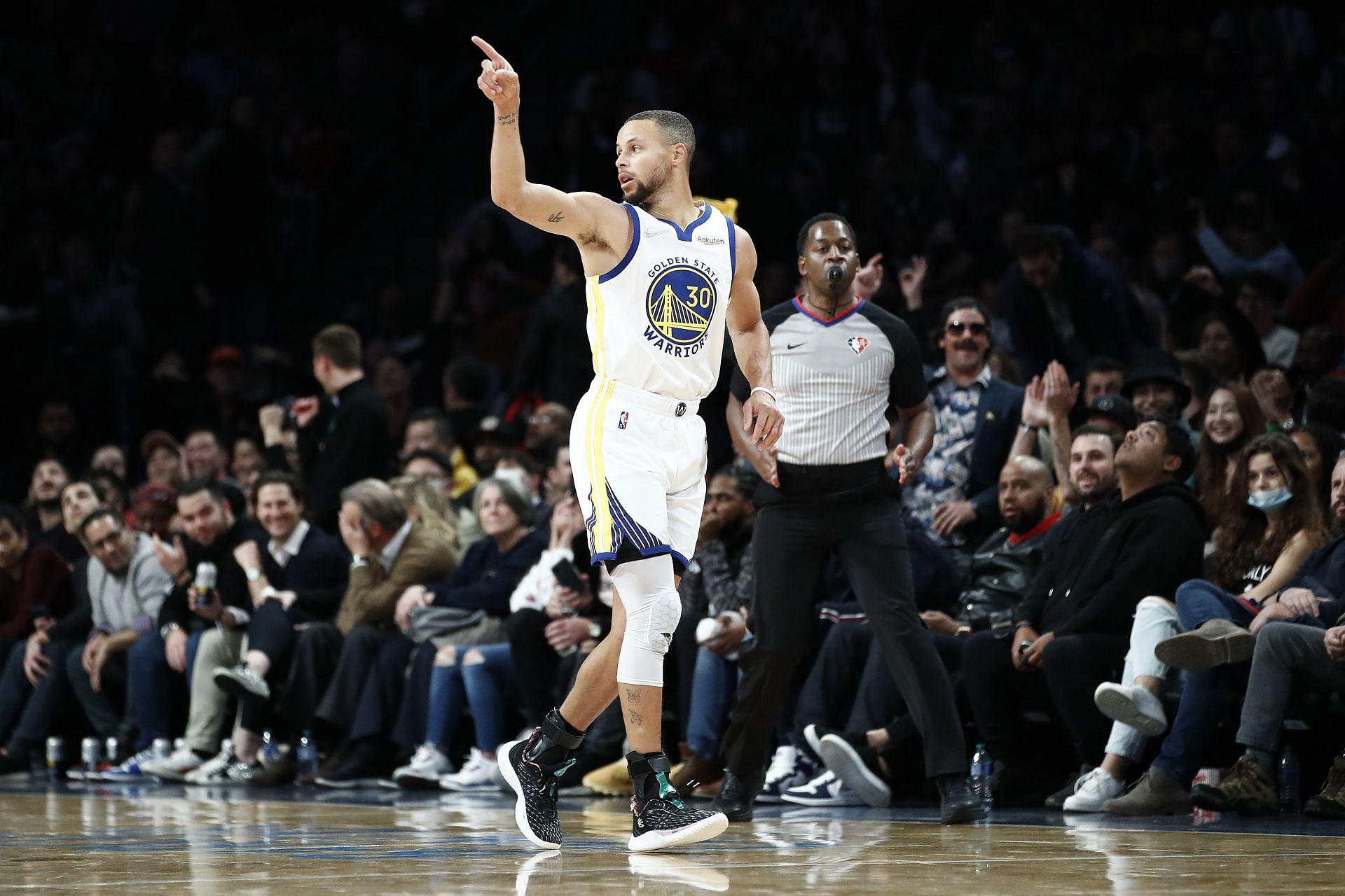 Stephen Curry of the Golden State Warriors reacts after making a basket during the second half against the Brooklyn Nets on Nov. 16, 2021.