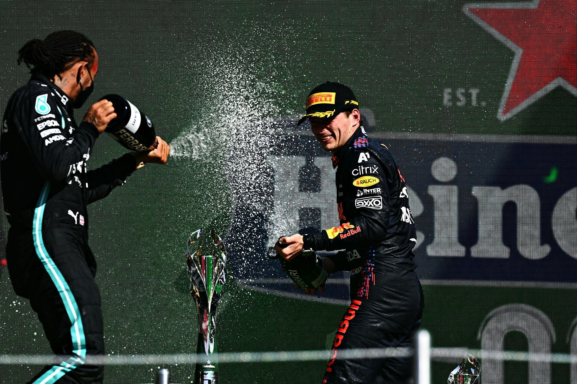 Lewis Hamilton and Max Verstappen celebrating on the podium. (Photo by Clive Mason/Getty Images)