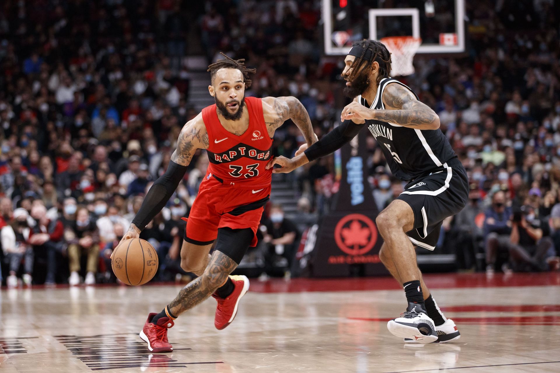 Gary Trent Jr. #33 of the Toronto Raptors drives to the net on DeAndre' Bembry #95 of the Brooklyn Nets during the second half of their NBA game at Scotiabank Arena on November 7, 2021 in Toronto, Canada.