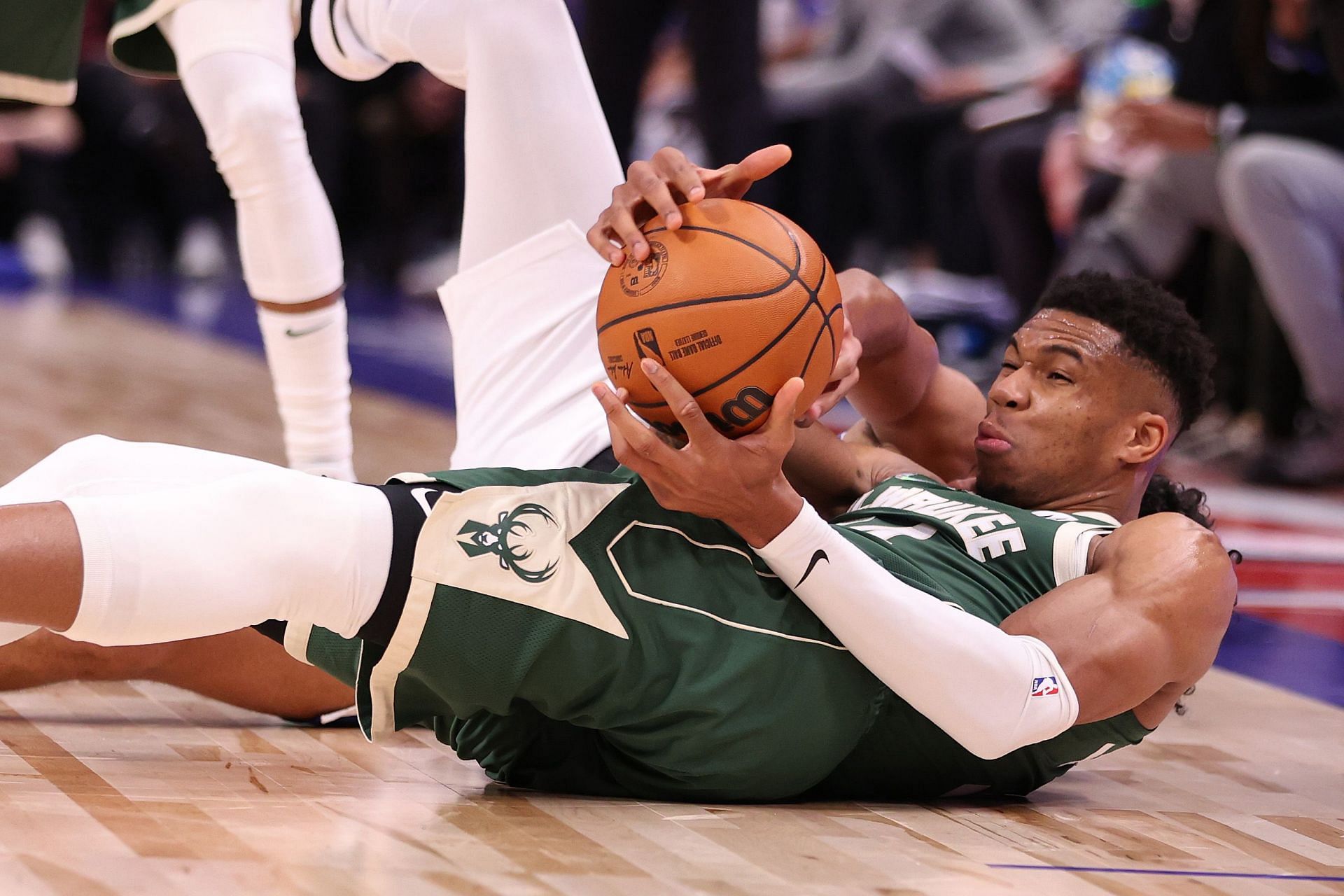 Giannis Antetokounmpo of the Milwaukee Bucks battles for the loose ball.