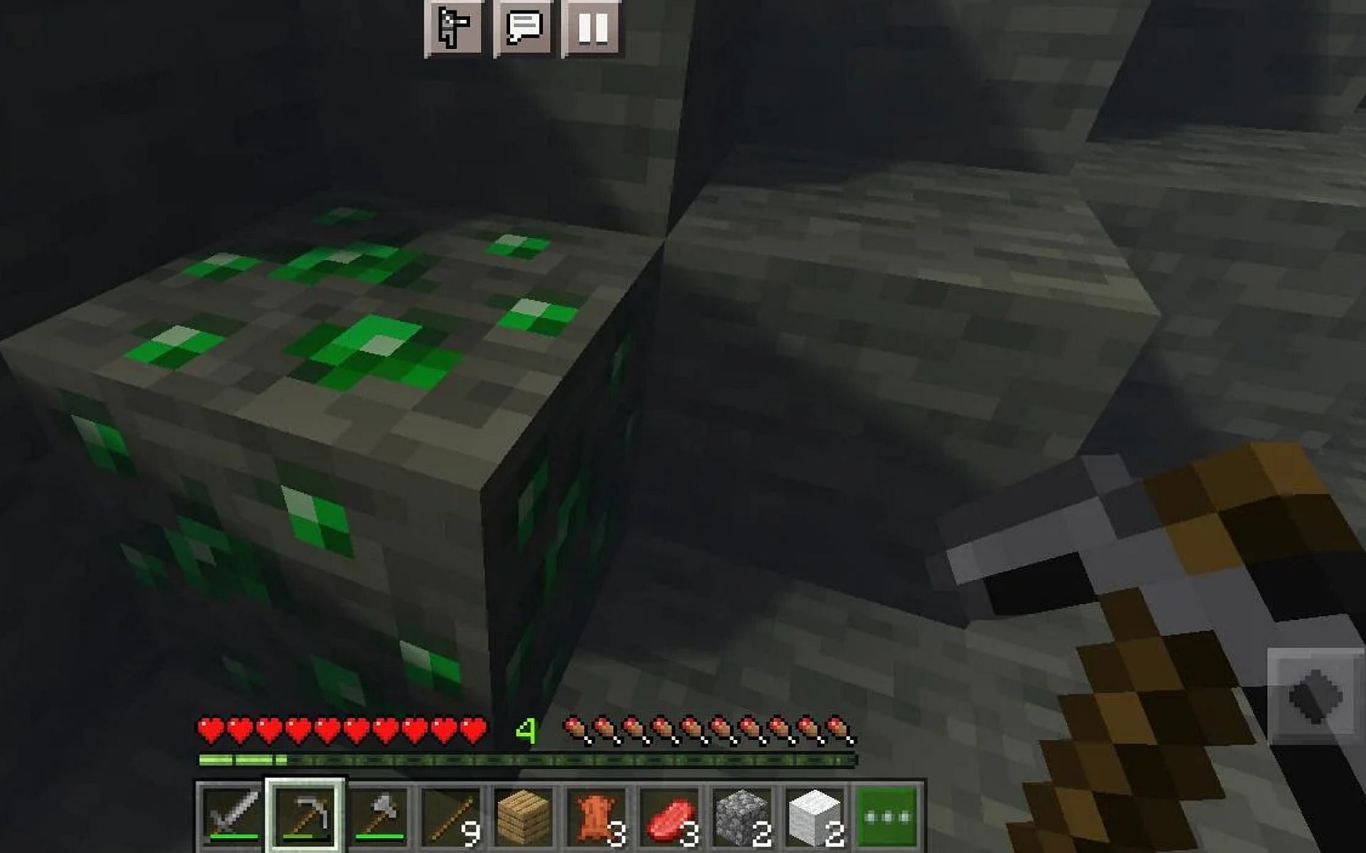 A player mines emeralds in-game. Image via Minecraft.