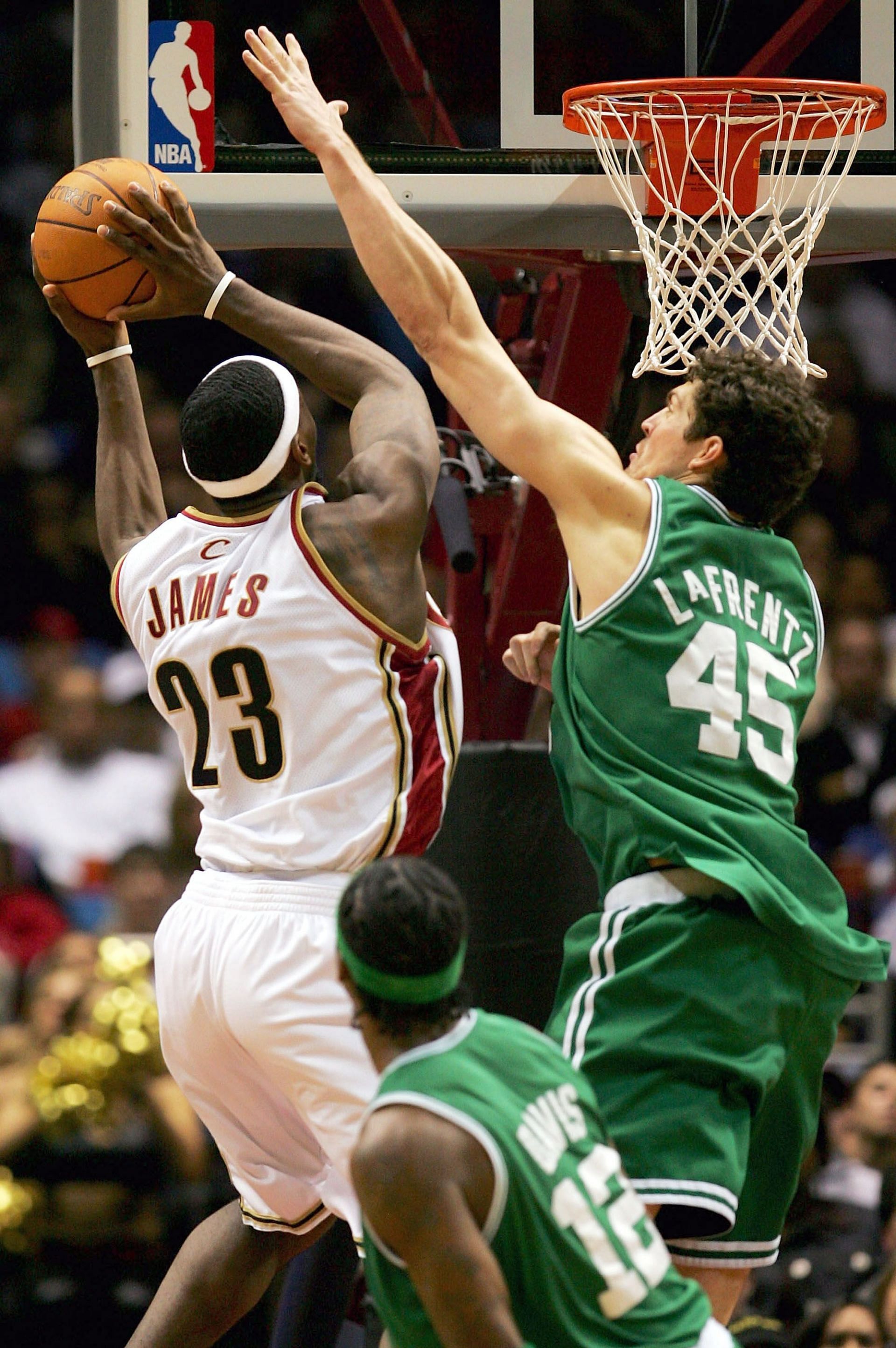 LeBron James #23 of the Cleveland Cavaliers drives to the basket against Raef LaFrentz #45 of the Boston Celtics