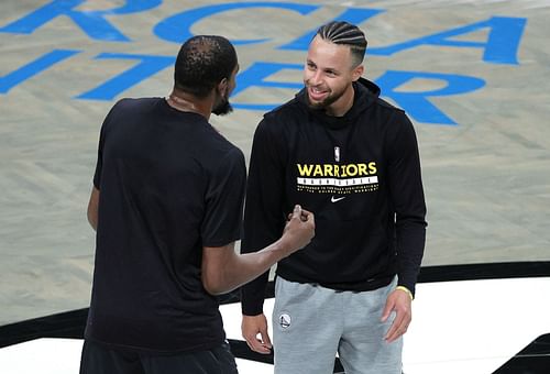 Kevin Durant, left, of the Brooklyn Nets talks with Stephen Curry of the Golden State Warriors