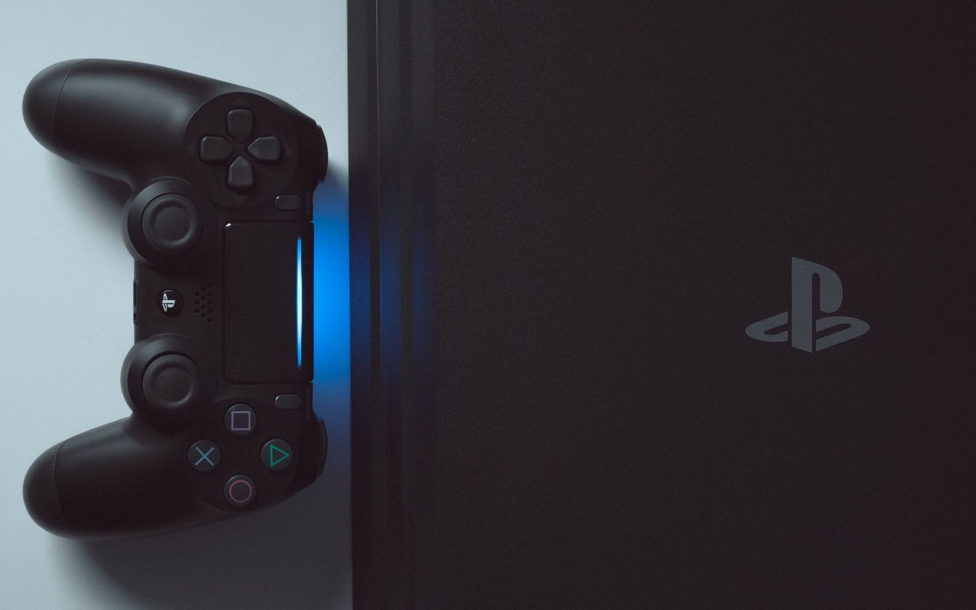 A PS4 pro with a Dualshock 4 controller (Image via unsplash.com)