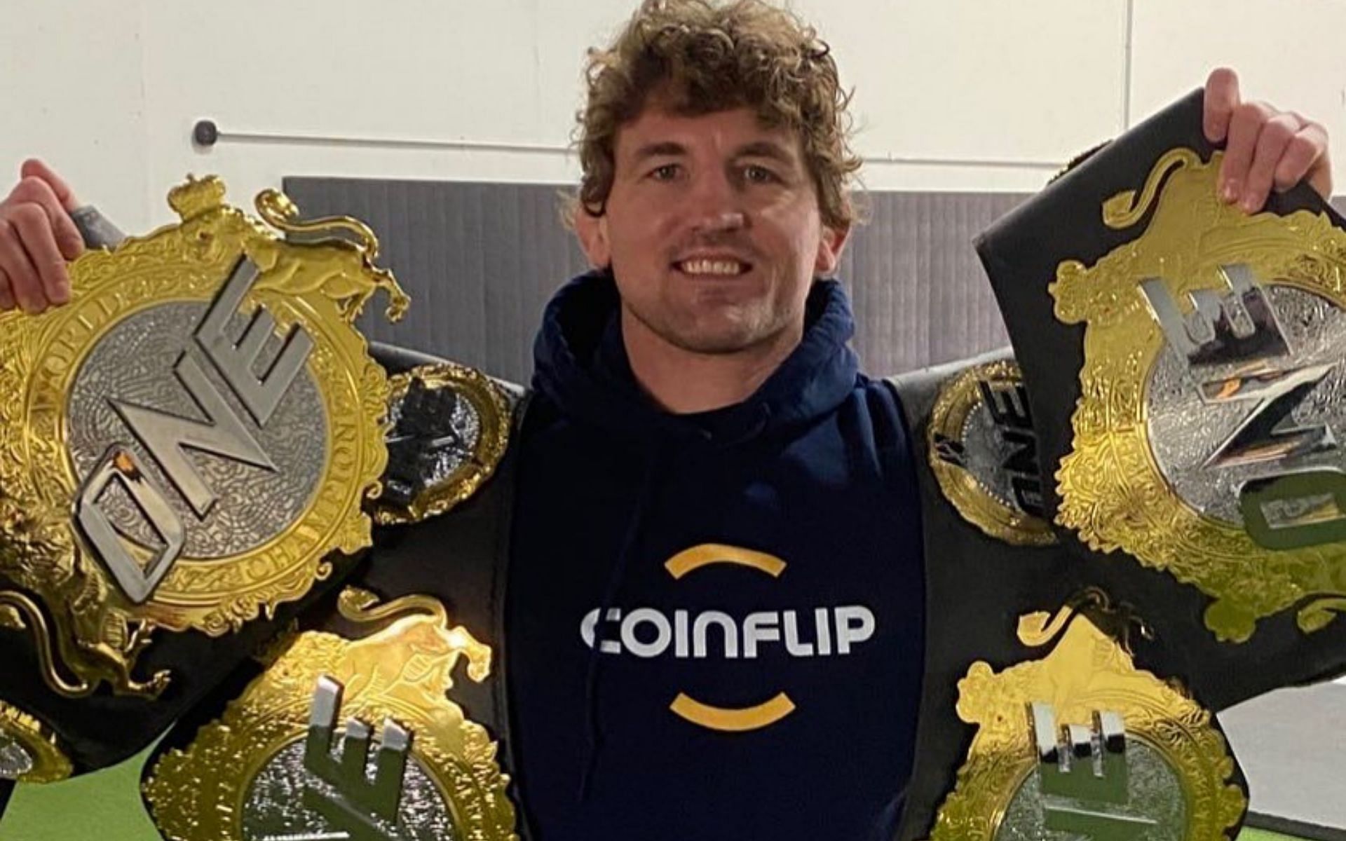 Ben Askren poses with his belts from One Championship and Bellator. Image credits: Instagram/benaskren