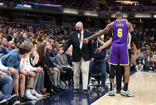 LeBron #6 points at the two fans who were later ejected