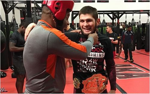 Khabib Nurmagomedov and Daniel Cormier laughing in the gym