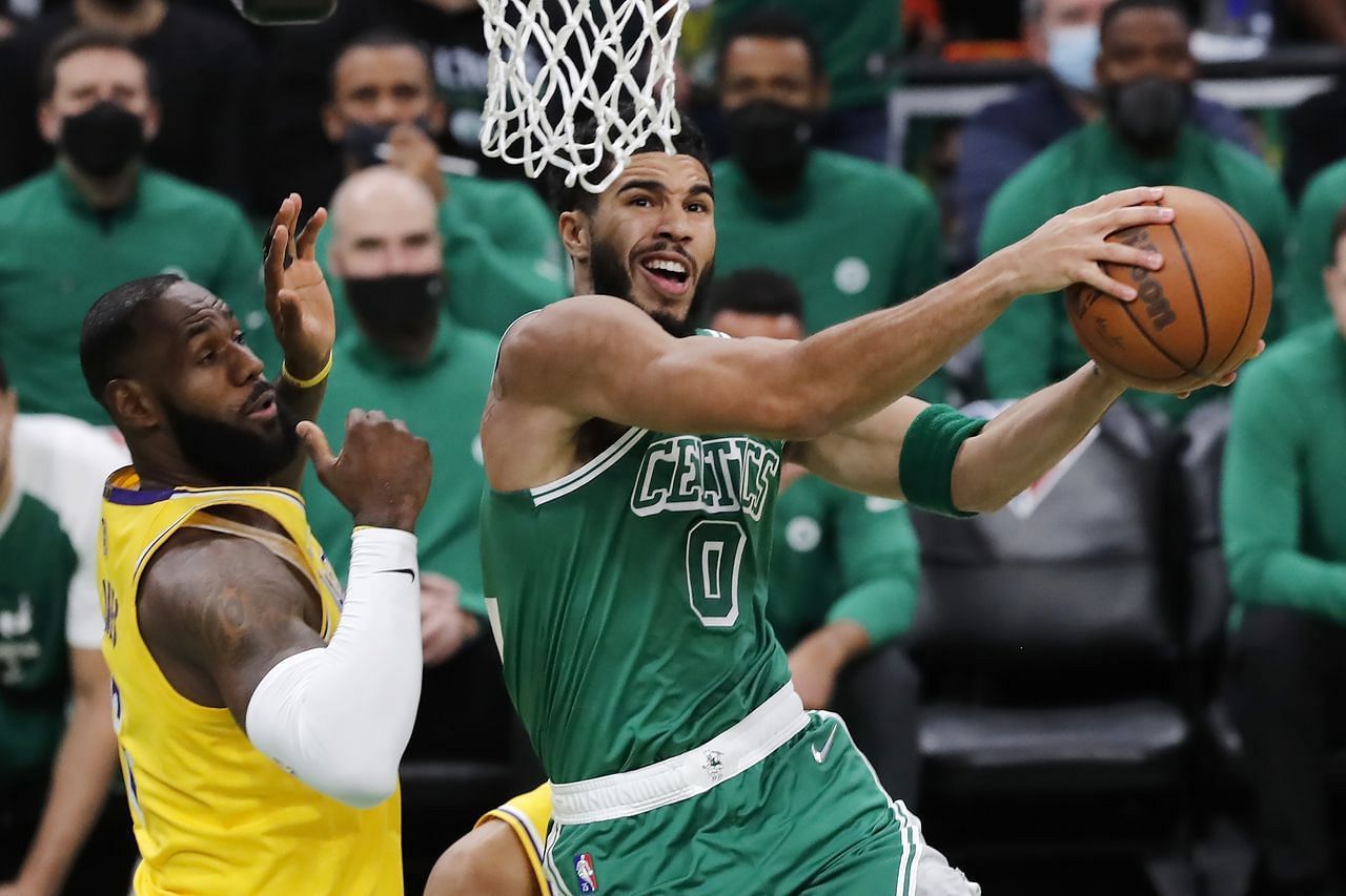 Jayson Tatum of the Boston Celtics scores over LA Lakers&#039; LeBron James