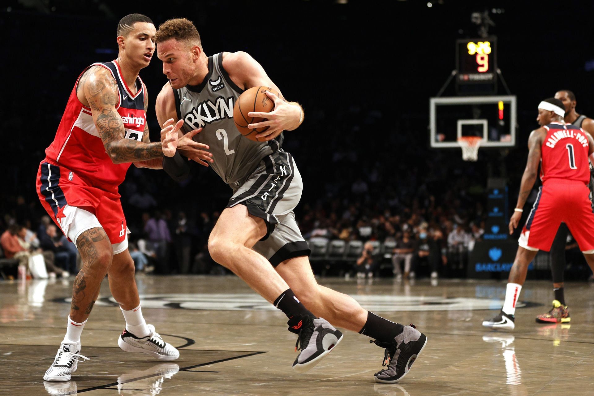 Blake Griffin #2 of the Brooklyn Nets dribbles against Kyle Kuzma #33 of the Washington Wizards