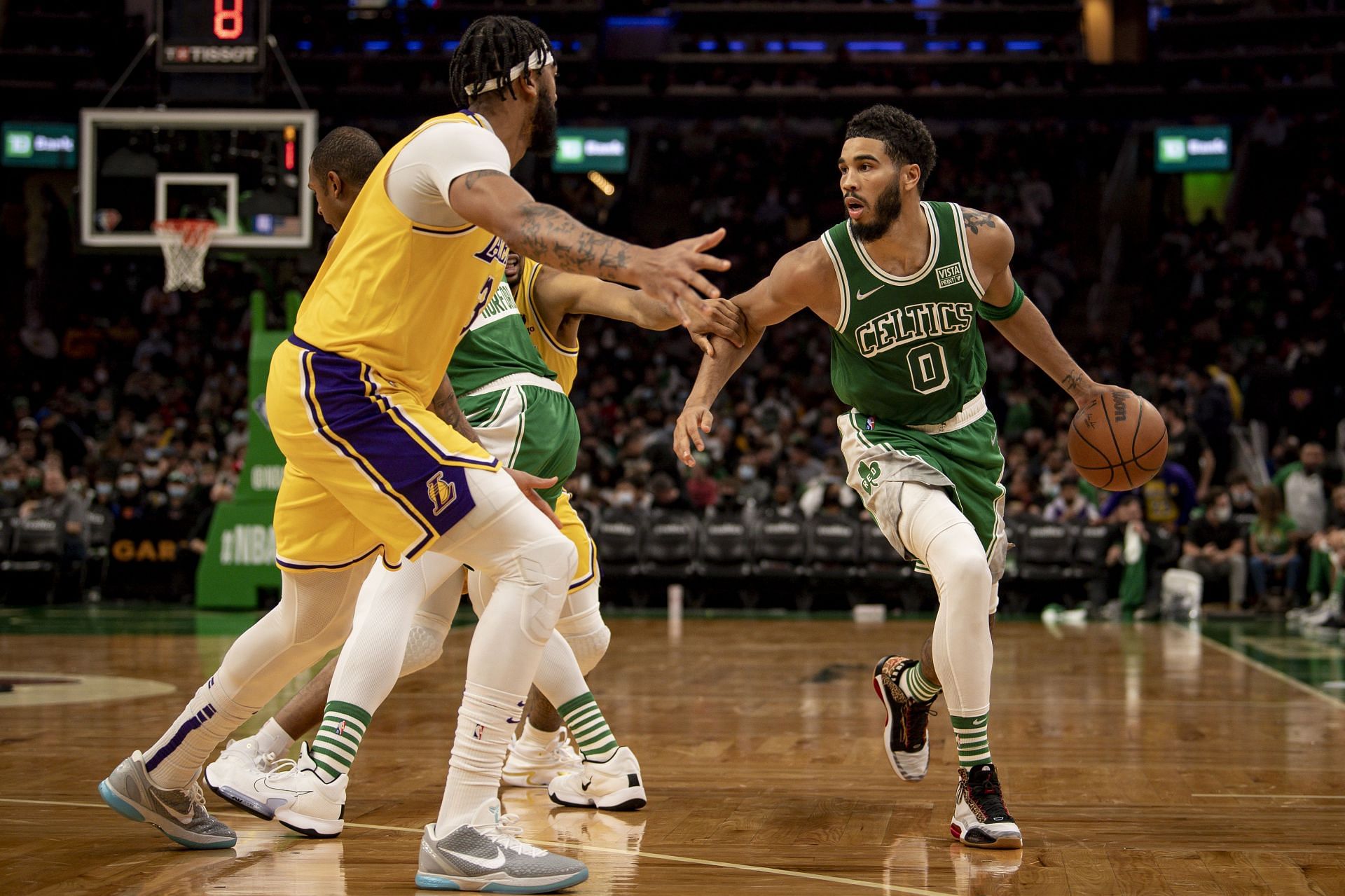 Anthony Davis of the Los Angeles Lakers guards Jayson Tatum of the Boston Celtics