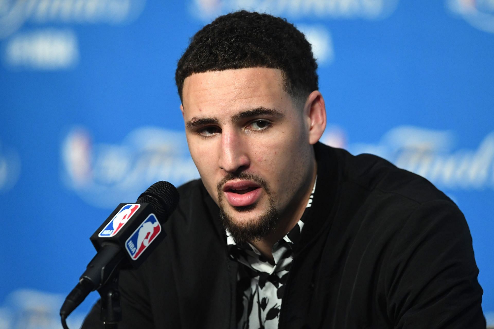 Klay Thompson #11 of the Golden State Warriors speaks to the media