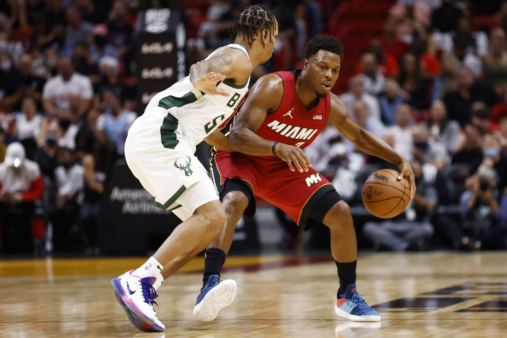 Kyle Lowry #7 of the Miami Heat is defended by Justin Robinson #55 of the Milwaukee Bucks at FTX Arena on October 21, 2021 in Miami, Florida.
