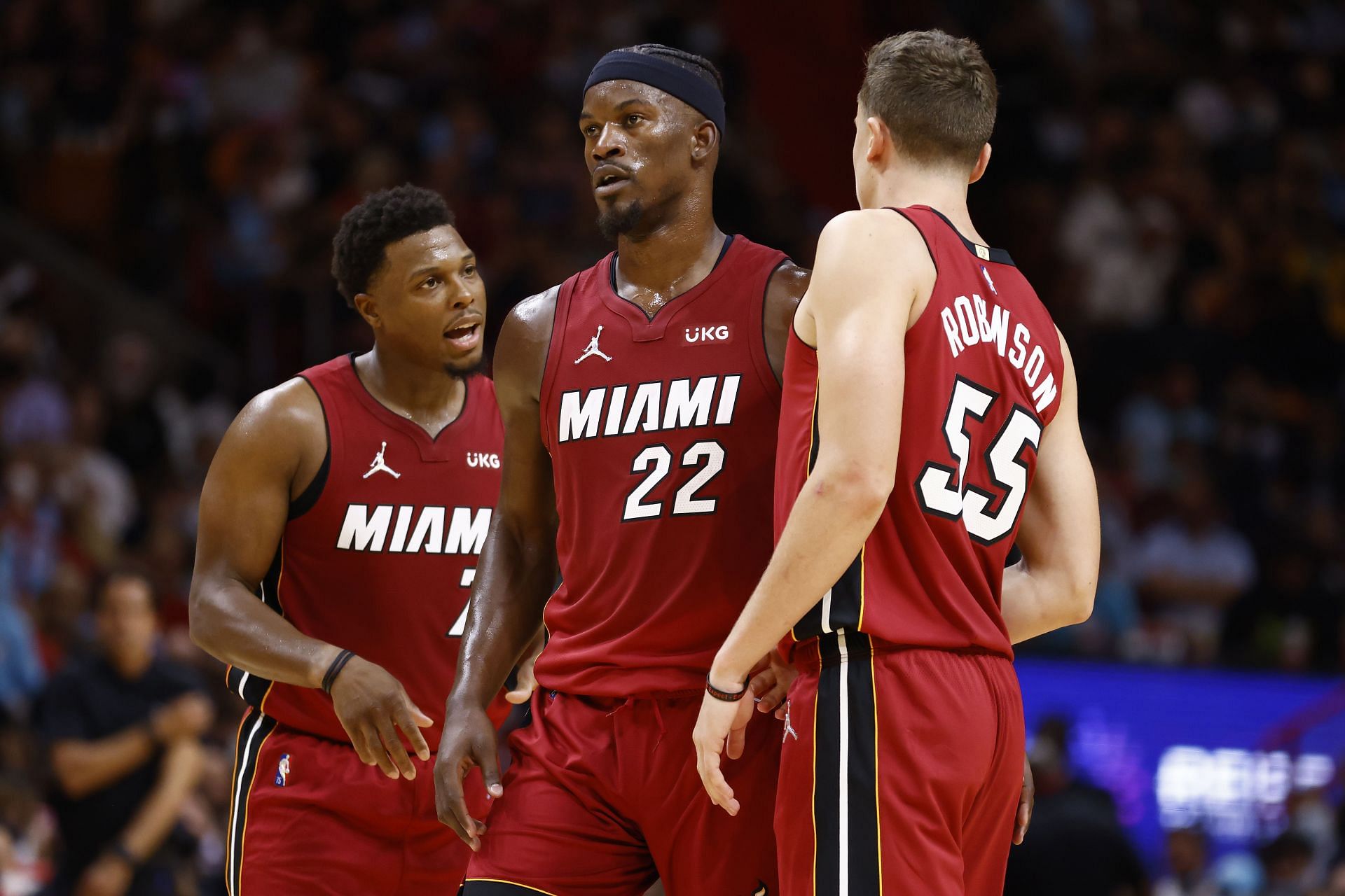 Kyle Lowry #7, Jimmy Butler #22, Duncan Robinson #55 of the Miami Heat look on.