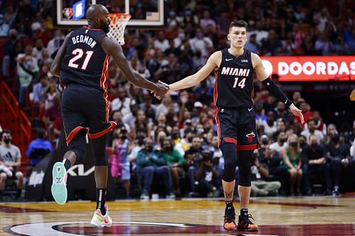 Dewayne Dedmon #21 and Tyler Herro #14 of the Miami Heat celebrate