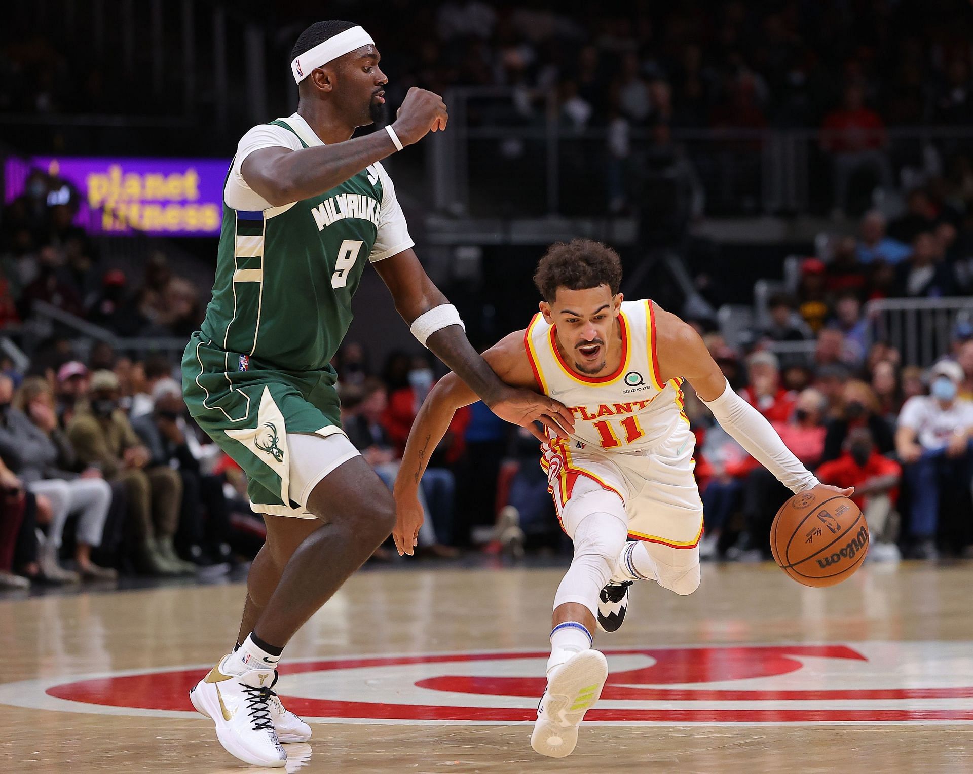 Trae Young #11 of the Atlanta Hawks drives against Bobby Portis #9 of the Milwaukee Bucks.