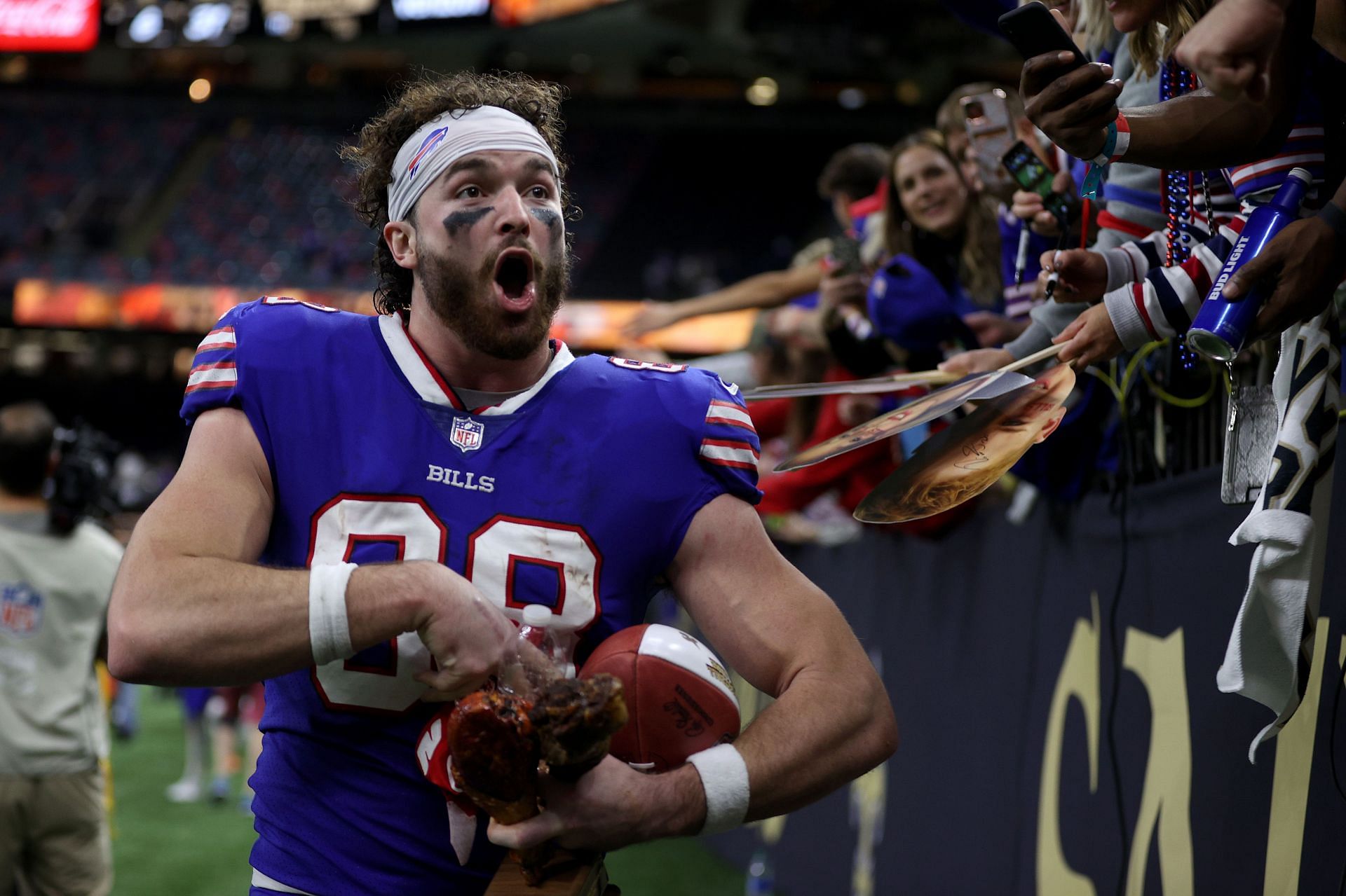 Tight end Dawson Knox celebrates with turkey after the Bills' Thursday victory over New Orleans