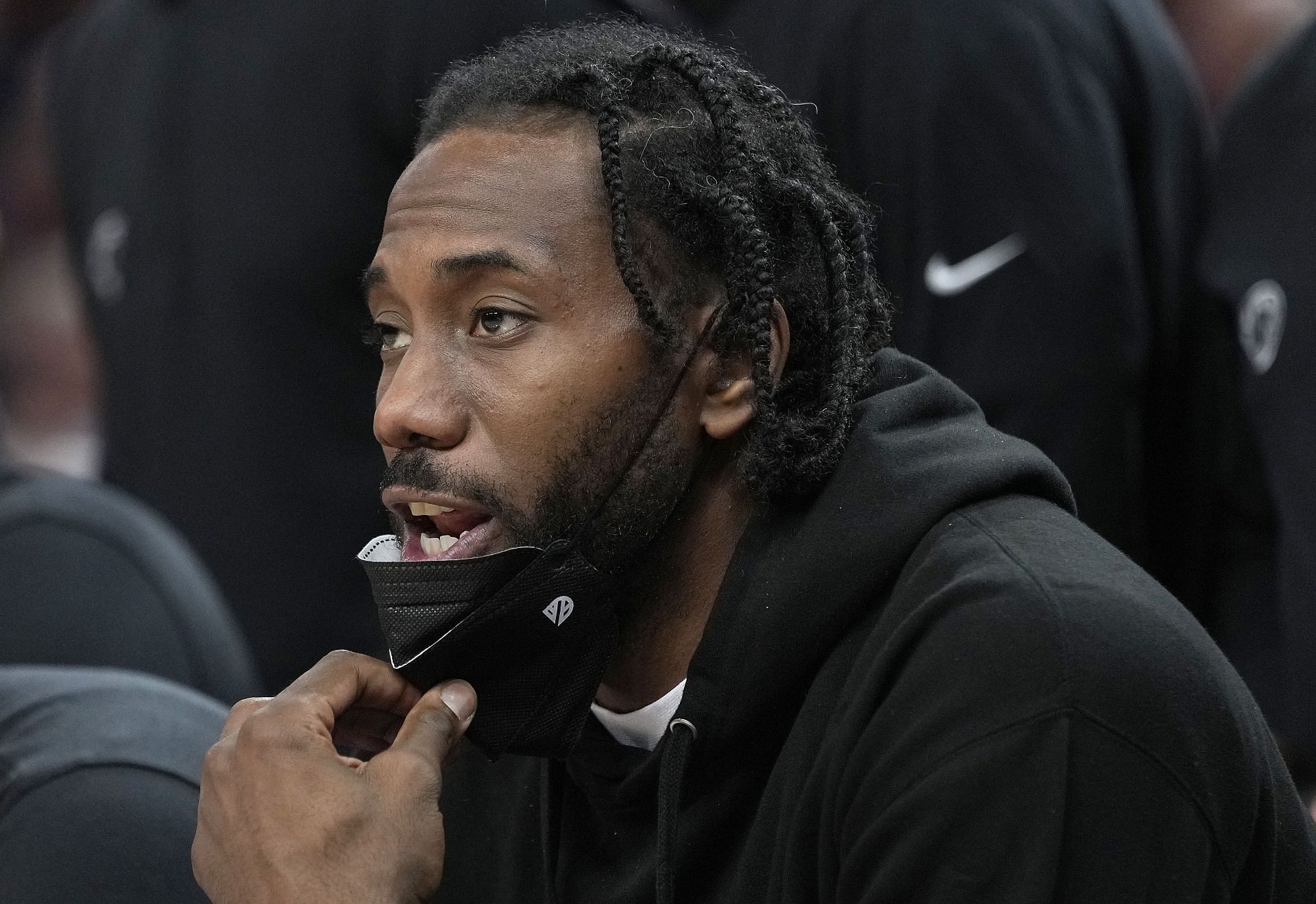 Injured player Kawhi Leonard #2 of the LA Clippers looks on from the bench against the Golden State Warriors during the fourth quarter at Chase Center on October 21, 2021 in San Francisco, California.