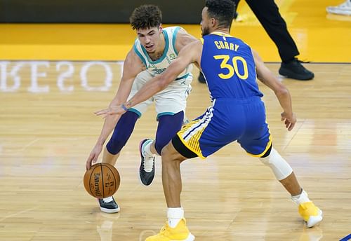 Stephen Curry of the Golden State Warriors guards Charlotte Hornets' LaMelo Ball.