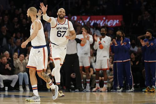 Taj Gibson #67 high-fives Evan Fournier #13 of the New York Knicks