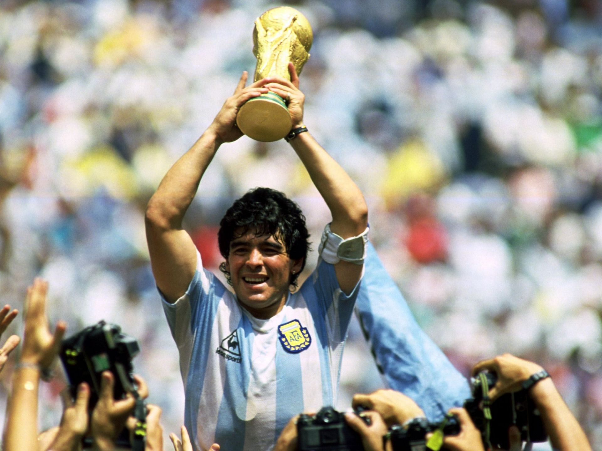 Diego Maradona with the World Cup trophy