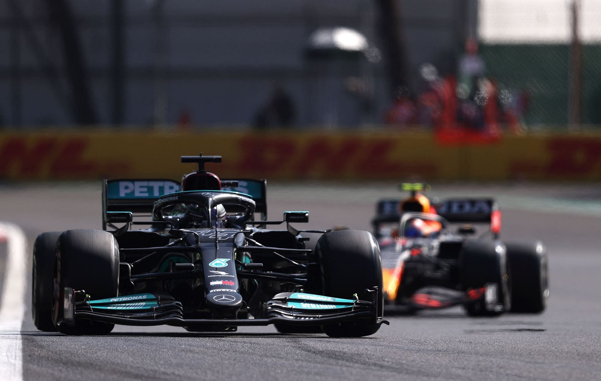 Lewis Hamilton pressured by Sergio Perez through the final laps of the 2021 Mexican GP. (Photo by Lars Baron/Getty Images)