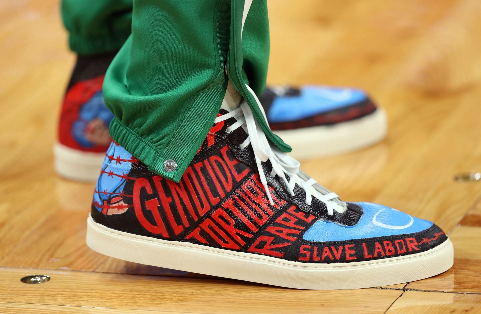 Enes Kanter of the Boston Celtics displays strong messages on his sneakers