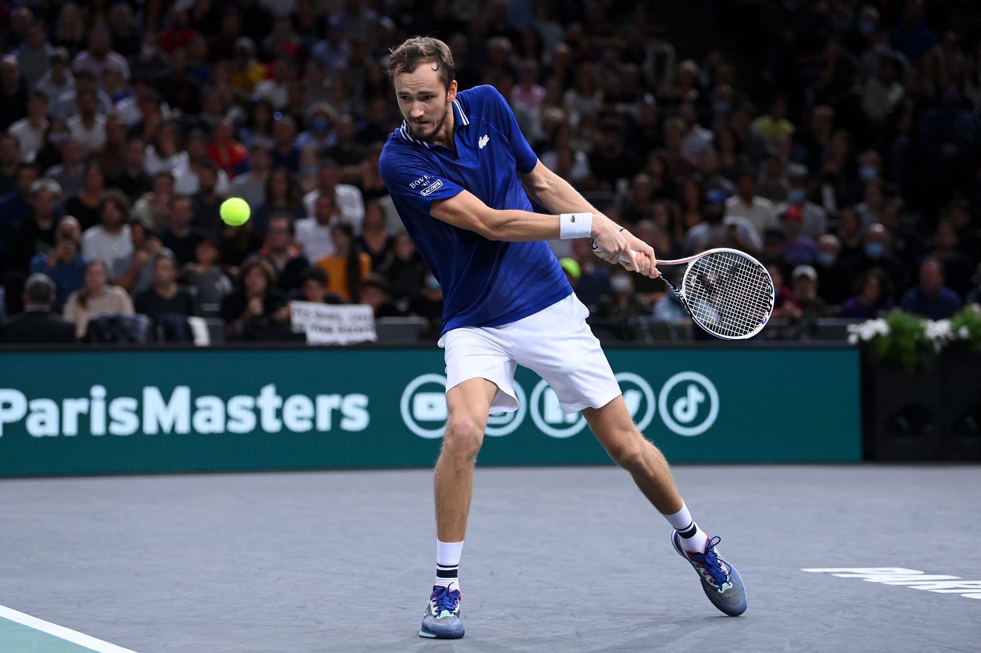 Daniil Medvedev hits a return against Novak Djokovic at the Rolex Paris Masters