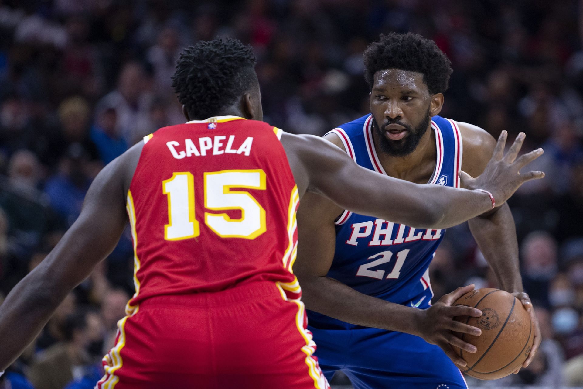 Joel Embiid looks to score while being guarded by Clint Capela