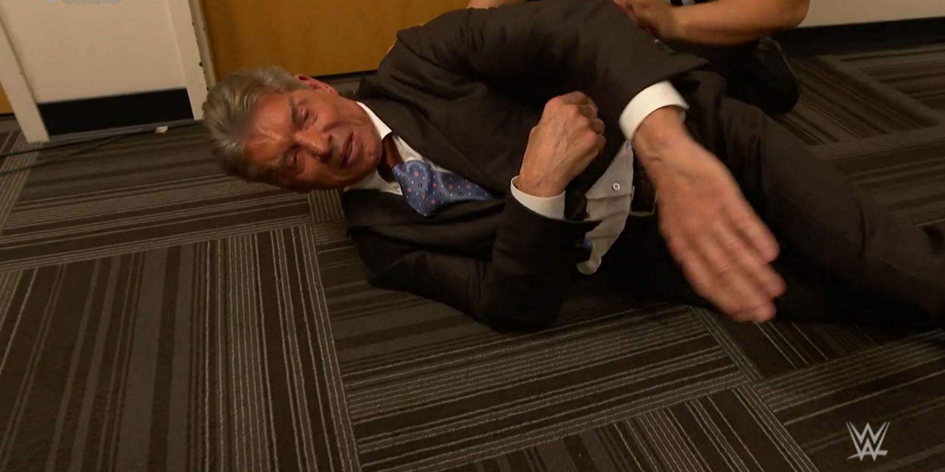 Vince McMahon on the floor after being punched by AJ Styles