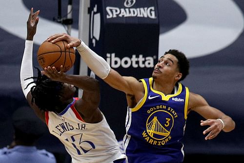 Jordan Poole of the Golden State Warriors blocks Kira Lewis Jr. of the New Orleans Pelicans.