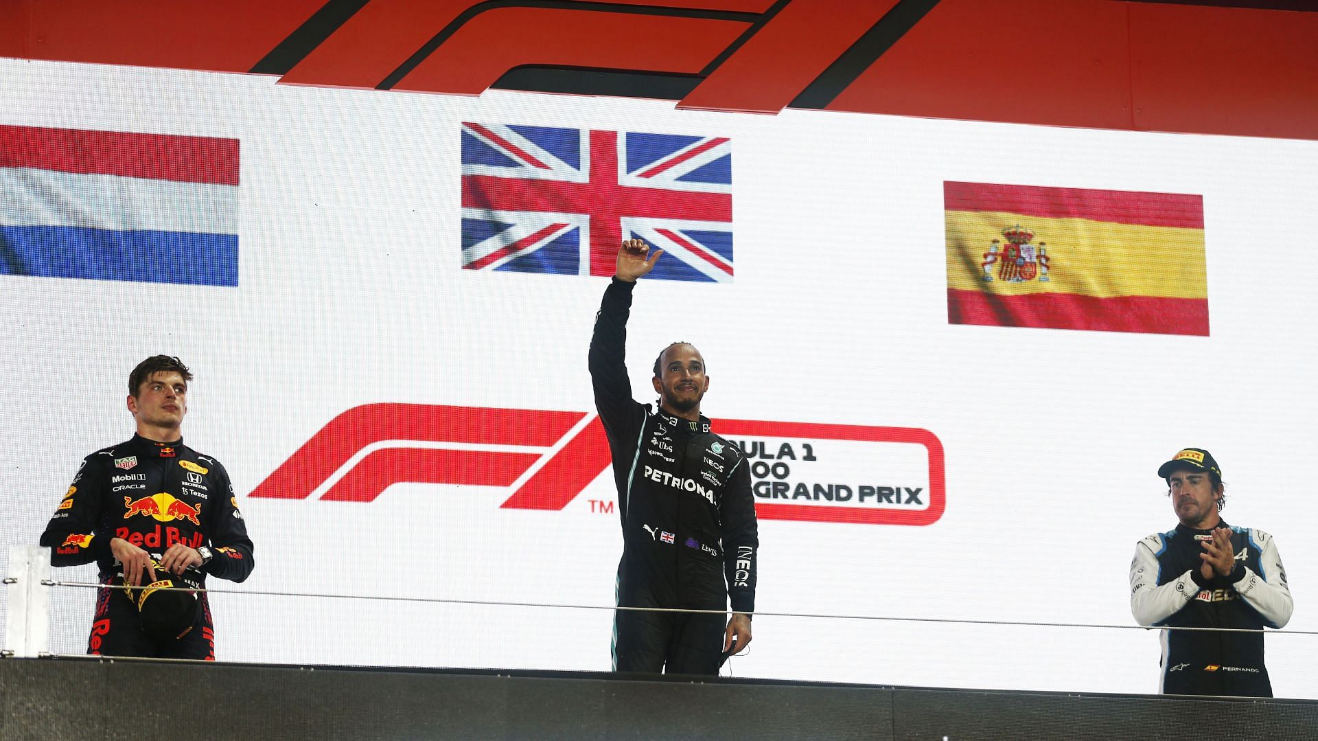 Race winner Lewis Hamilton, second-placed Max Verstappen, and third-placed Fernando Alonso celebrate on the Qatar GP podium.