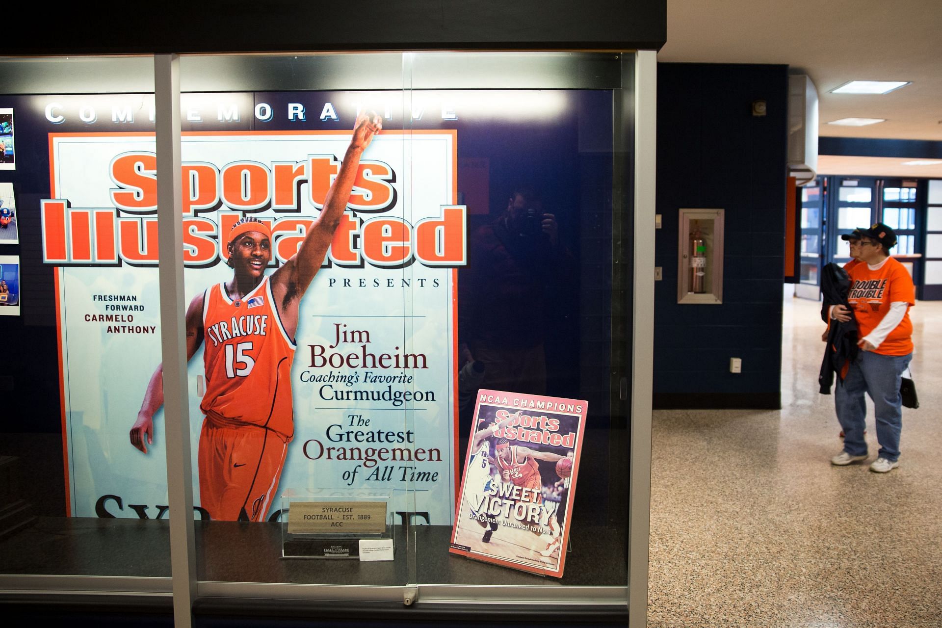 Fans file in past a display commemorating the men's team championship season under Carmelo Anthony