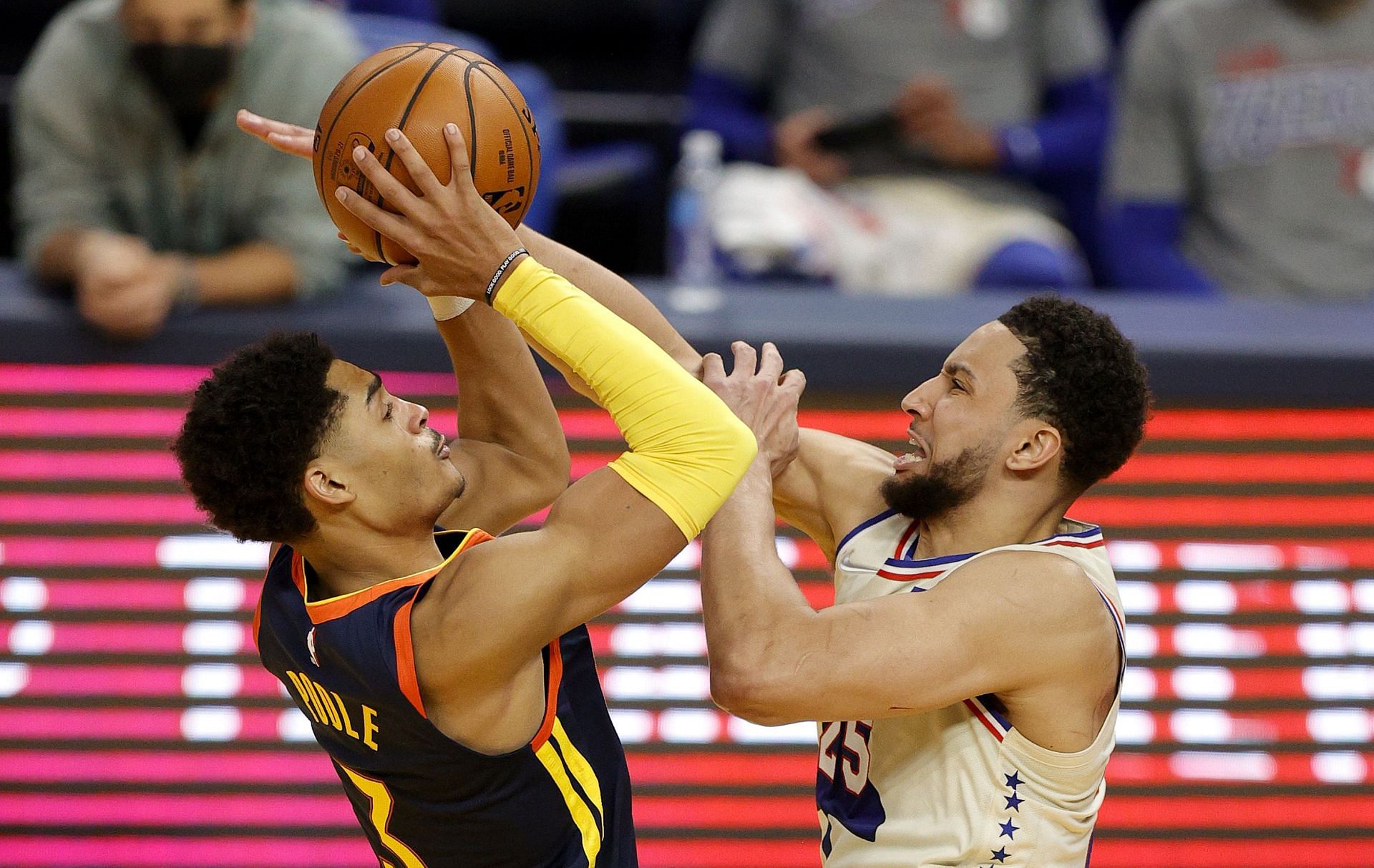 Ben Simmons of the Phildelphia 76ers defends Jordan Poole of the Golden State Warriors.