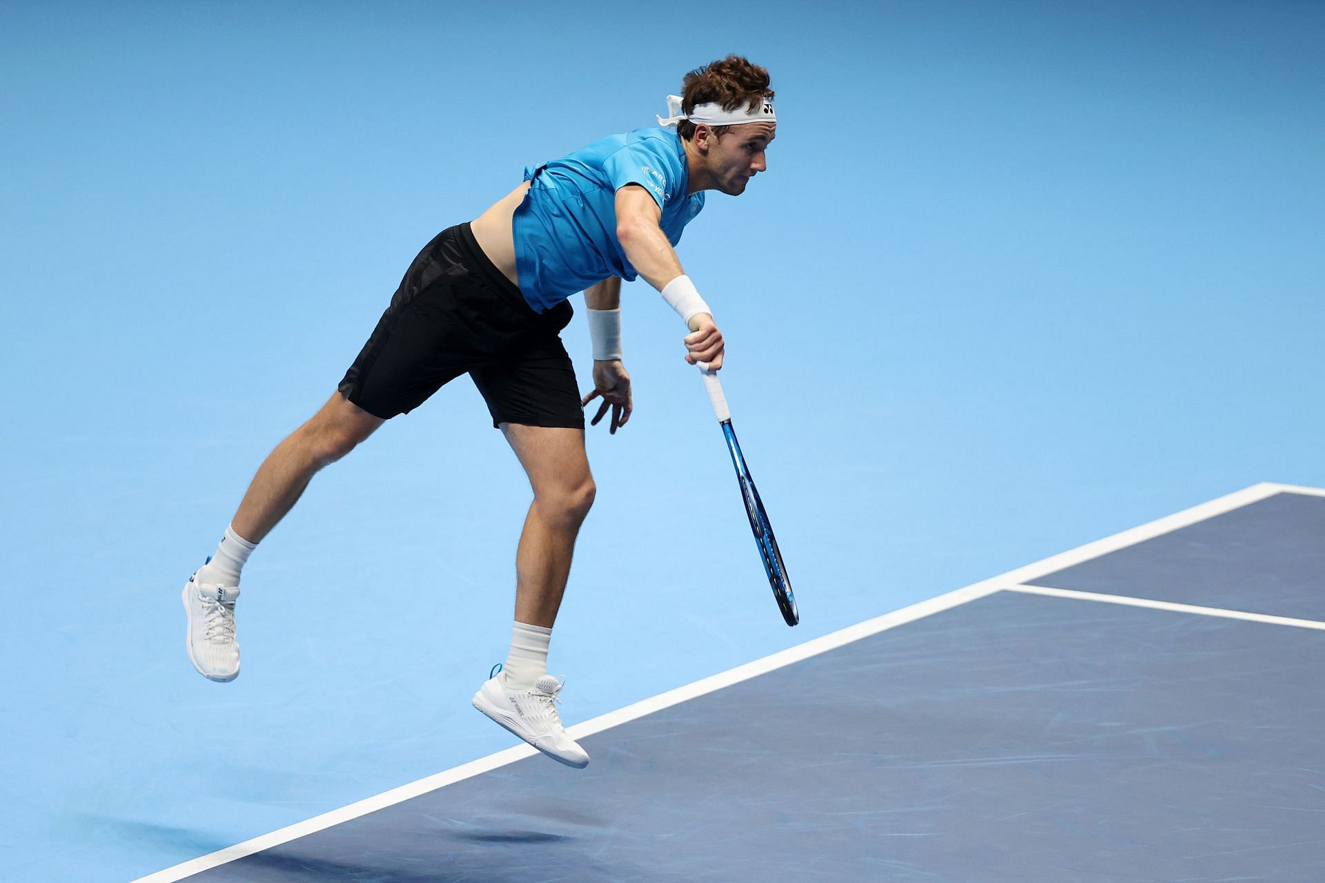 Casper Ruud serves against Novak Djokovic at the Nitto ATP World Tour Finals