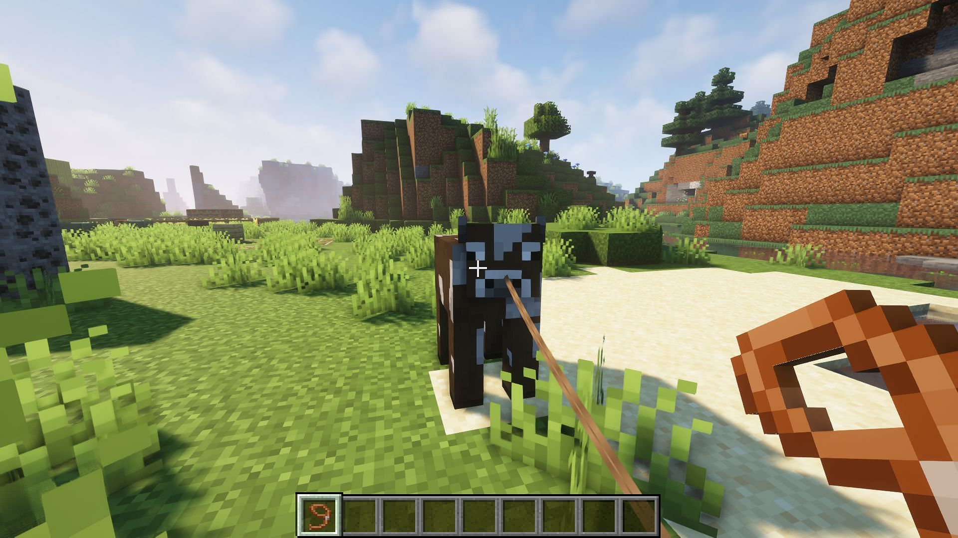 A cow tied to a lead (Image via Minecraft)