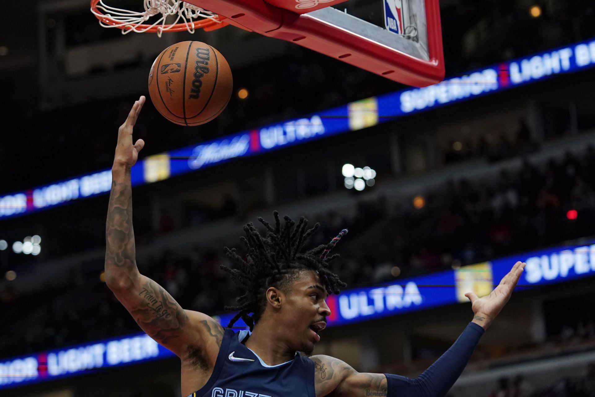 Ja Morant #12 of the Memphis Grizzlies reacts after making a basket against the Chicago Bulls in the second half during a preseason game at United Center on October 15, 2021 in Chicago, Illinois.