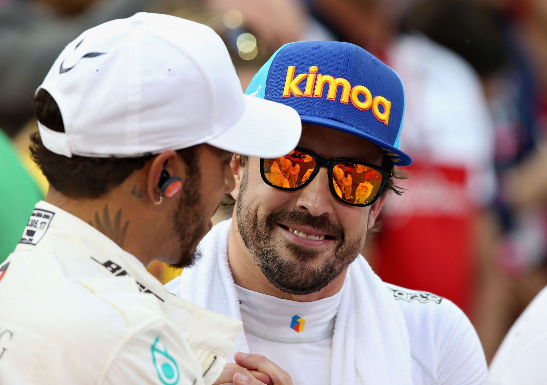 Lewis Hamilton and Fernando Alonso of Spain in the F1 paddock. (Photo by Clive Mason/Getty Images)