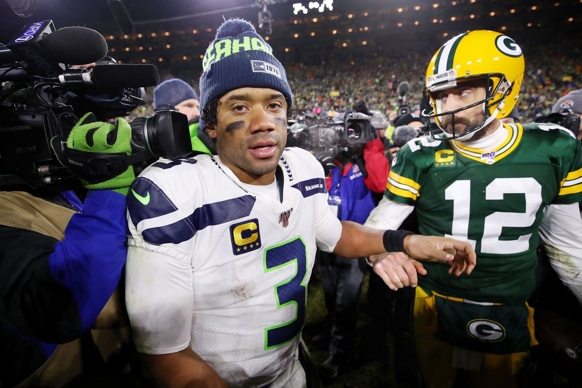Russell Wilson (3) and Aaron Rodgers (12) meet at midfield following their team&#039;s NFC Divisional playoff showdown in January 2020 (Photo: Getty)