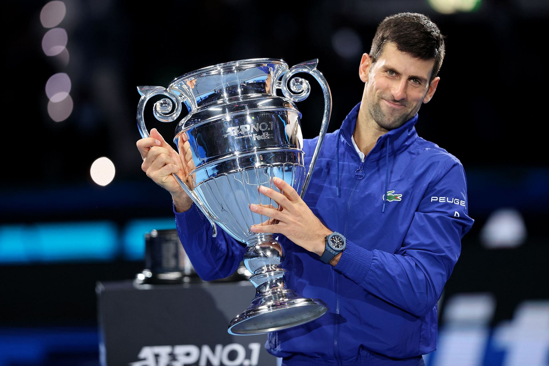 Novak Djokovic holds his Year-End No. 1 trophy at the Nitto ATP Finals.