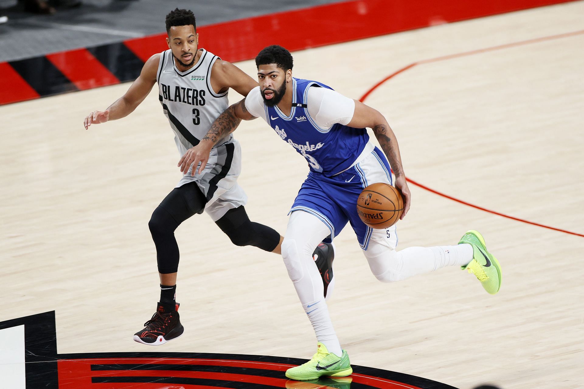 Anthony Davis of the Los Angeles Lakers drives against CJ McCollum of the Portland Trail Blazers.