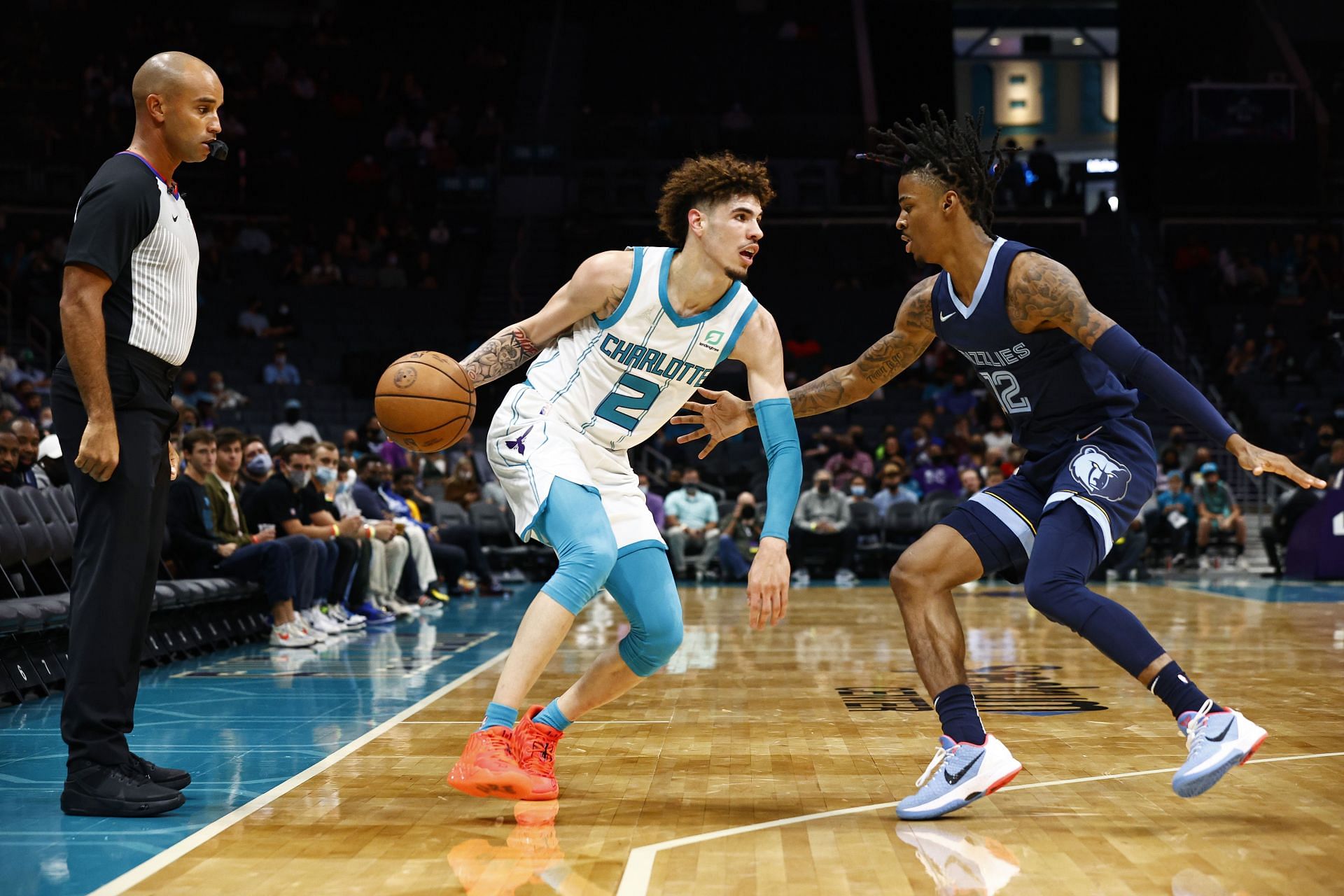 Ja Morant of the Memphis Grizzlies (#12) guards LaMelo Ball of the Charlotte Hornets (#2)