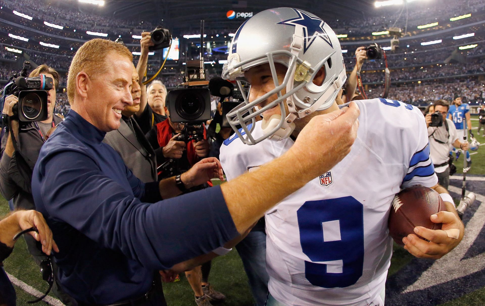 Jason Garrett (L) and Tony Romo embrace after the Cowboys' dramatic Wild Card victory during the NFL's 2015 postseason (Photo: Getty)