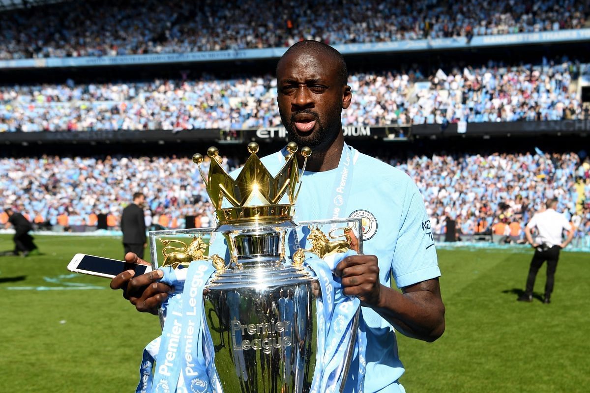 Yaya Toure posing with the Premier League trophy