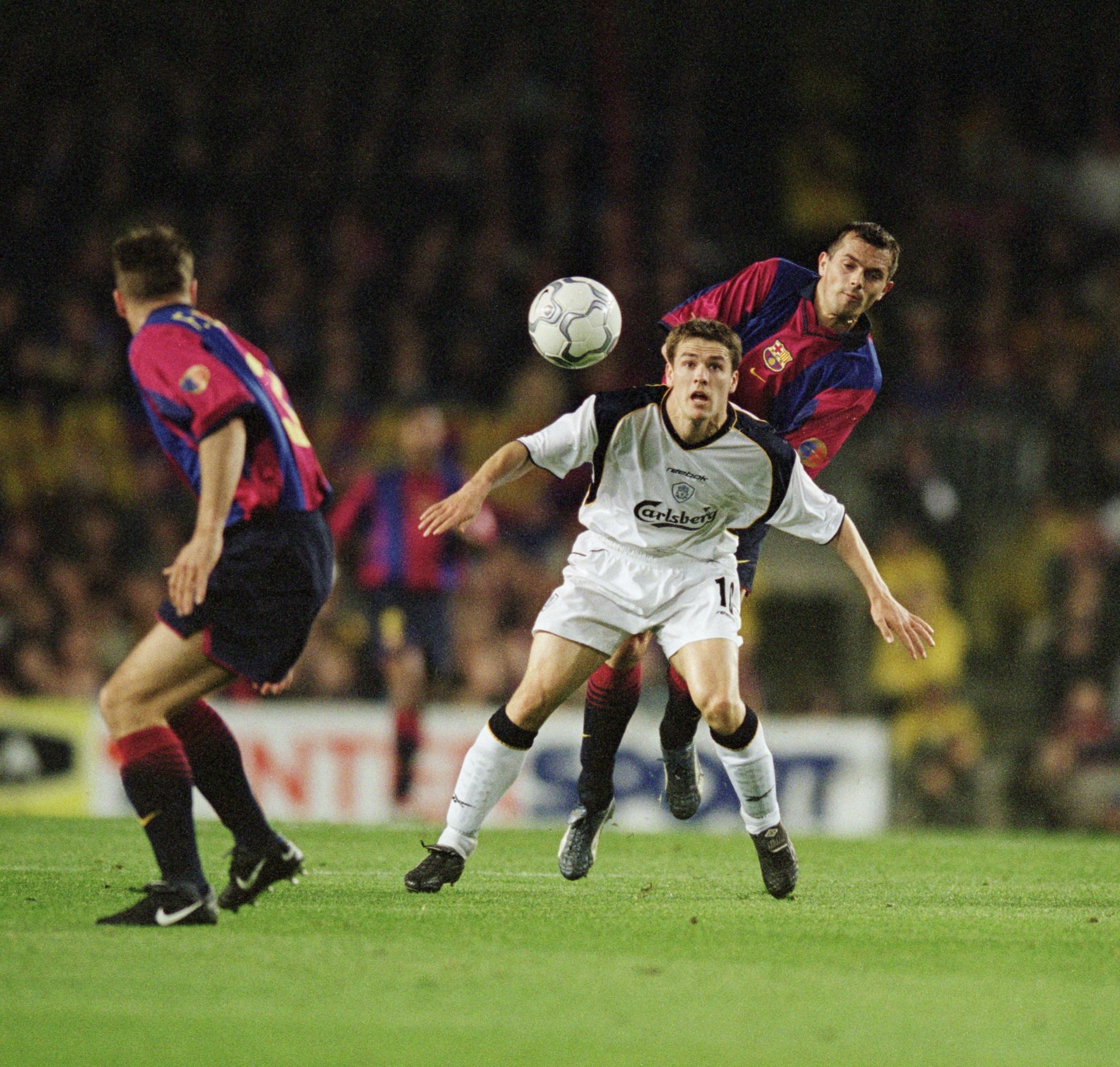 Phillip Cocu (right) tussles for the ball with Michael Owen (centre).